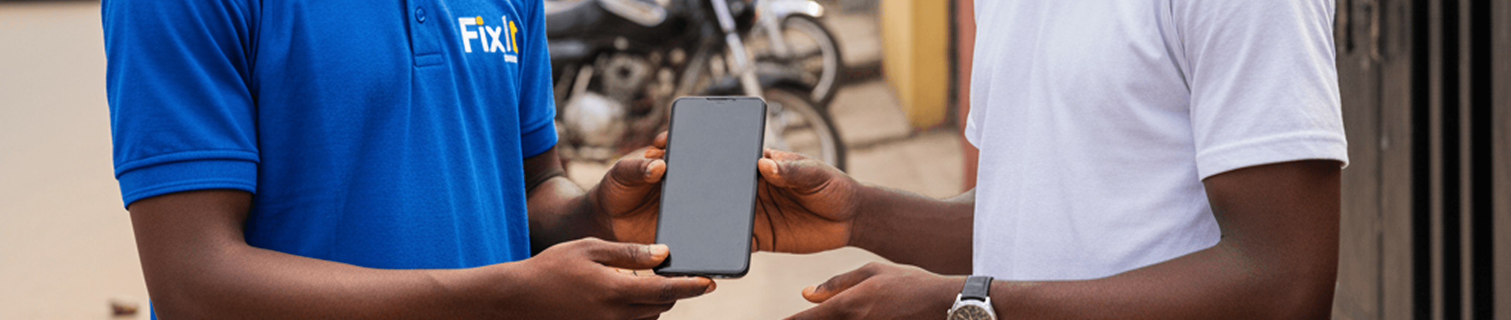 Technician handing phone to customer
